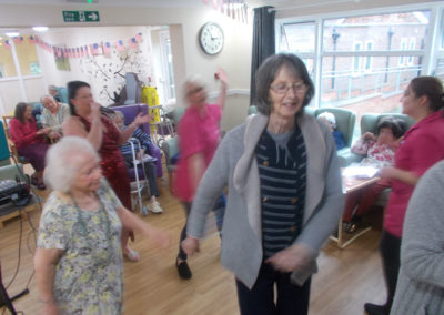 Staff and residents dancing together