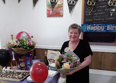 Manager Jean with her birthday bouquet at Sonya Lodge Residential Care