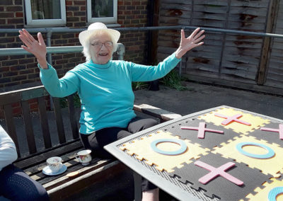 Sonya Lodge Residential Care Home resident smiling winning a game of giant noughts and crosses