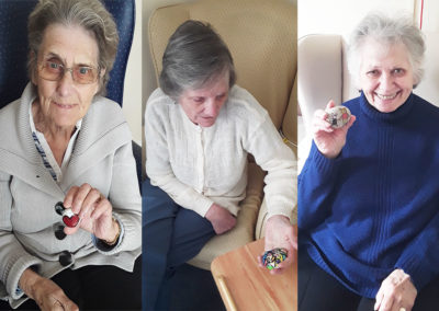 Residents with painted rocks at Sonya Lodge