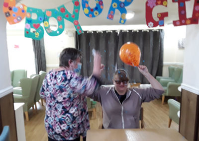 Sonya Lodge Residential Care Home staff member revealing her baby is a boy with blue balloon confetti