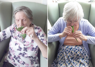 Two lady residents smelling herbs at Sonya Lodge Residential Care Home