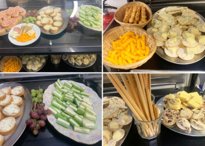 A selection of savoury snacks including pate, cheese and grapes on a trolley