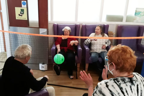 Sonya Lodge Residential Care Home residents playing seated badminton with a net and balloon
