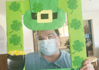 Staff member with a St Patricks Day selfie frame at Sonya Lodge Residential Care Home