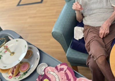 Resident enjoying an Alice in Wonderland afternoon tea at Sonya Lodge Residential Care Home