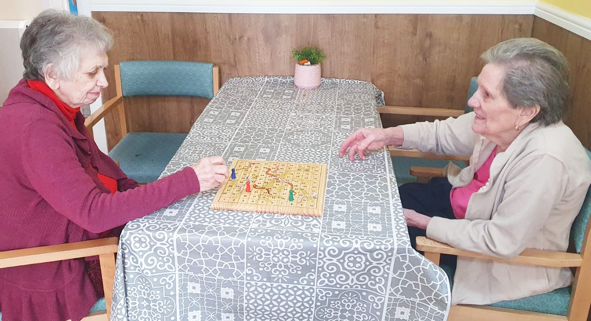 Sonya Lodge Residential Care Home residents playing a board game together
