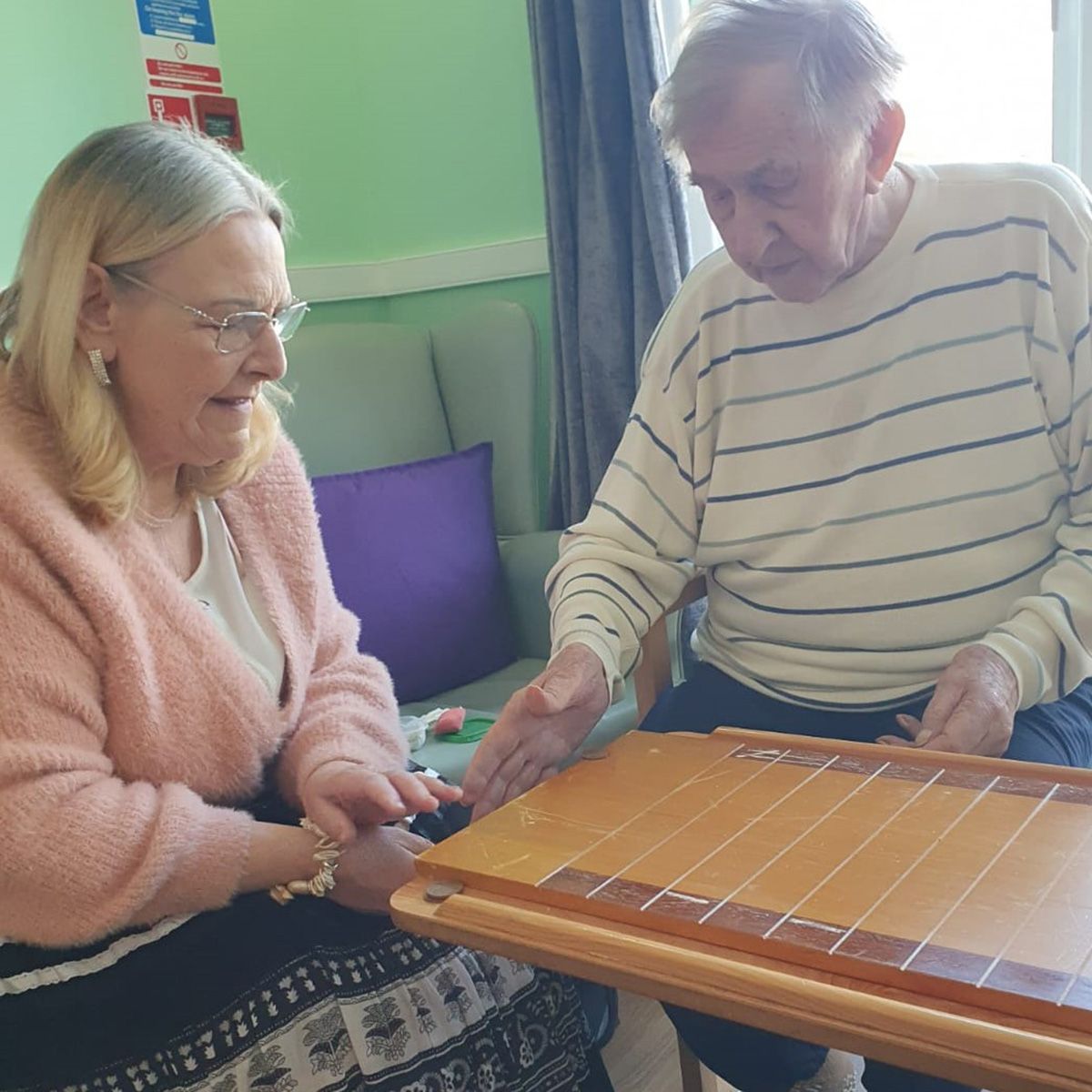 Playing Shove Ha'Penny at Sonya Lodge Residential Care Home